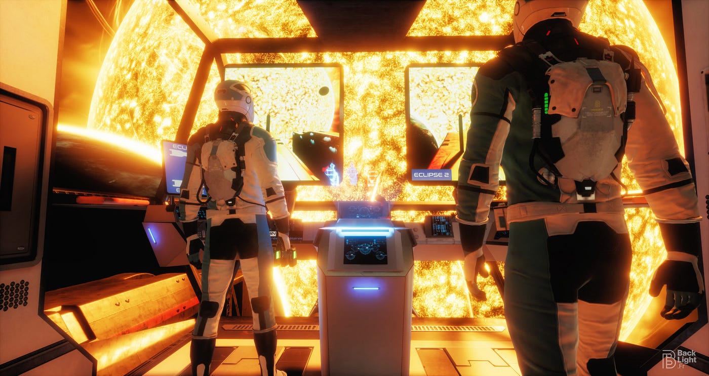 Two people are standing in a small chamber, with their backs in view. They’re wearing helmets and space suits. The vessel they’re in is hexagonal with large window-like panes. Small screens and illuminated consoles are present. Through the front of the vessel is a massive star, bursting with solar flares.