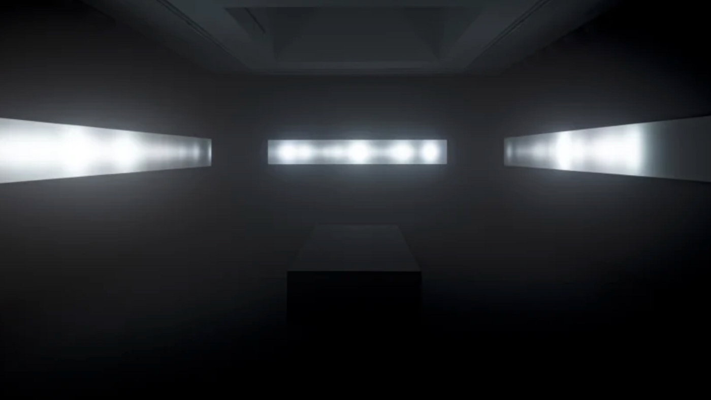 A dark room, almost completely black. There are no visible seams where the black velvet walls meet the black carpeted floor. A black box sits in the center and three long splices of light stretch across the walls.